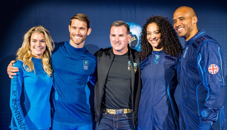 Under Armour Founder Kevin Plank stand with models wearing the UA-designed base layer and spacesuit.-2